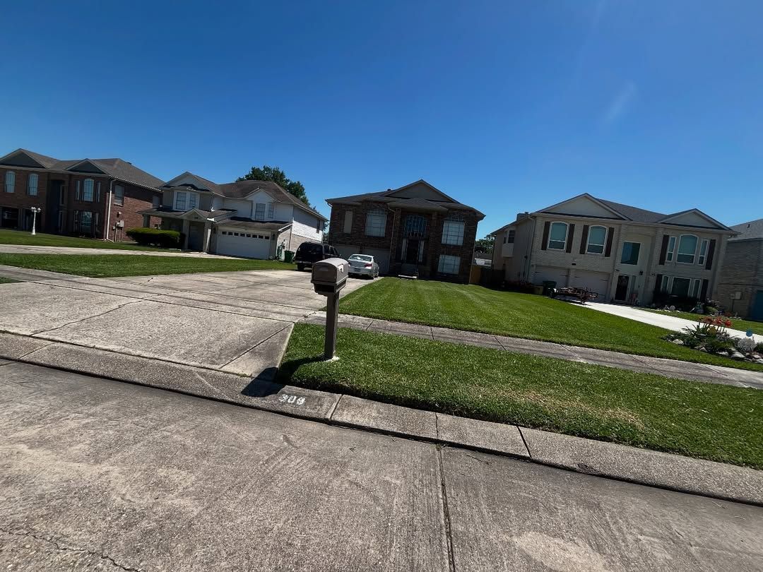 A row of houses in a residential neighborhood with a mailbox in the middle of the street.