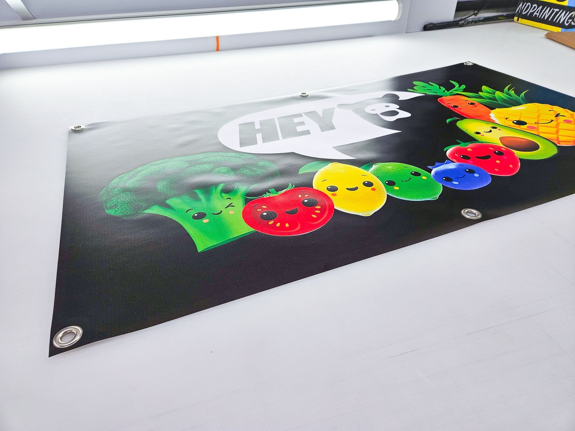 A black banner with a picture of fruits and vegetables on it.