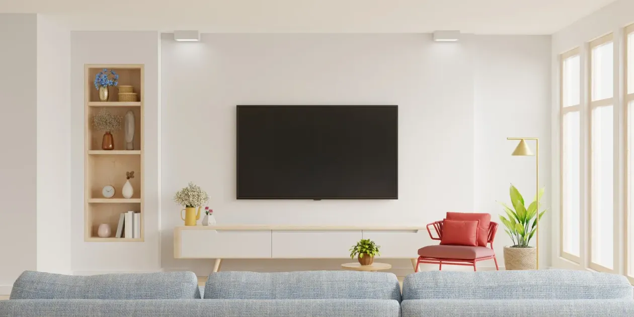 A living room with a flat screen tv mounted on the wall.