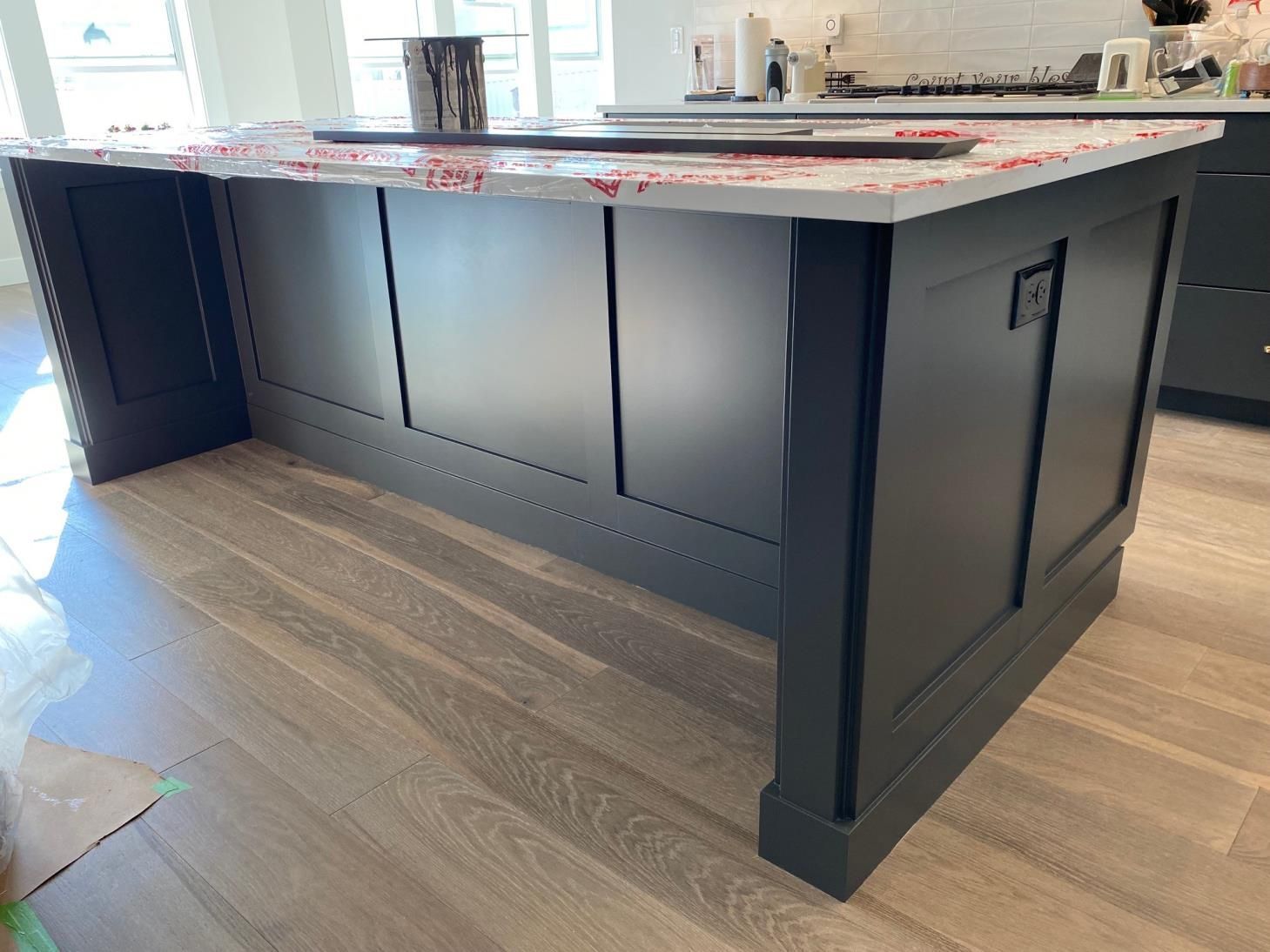A kitchen with a large island and a sink.