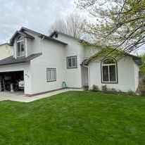 A large white house with a large lawn in front of it.