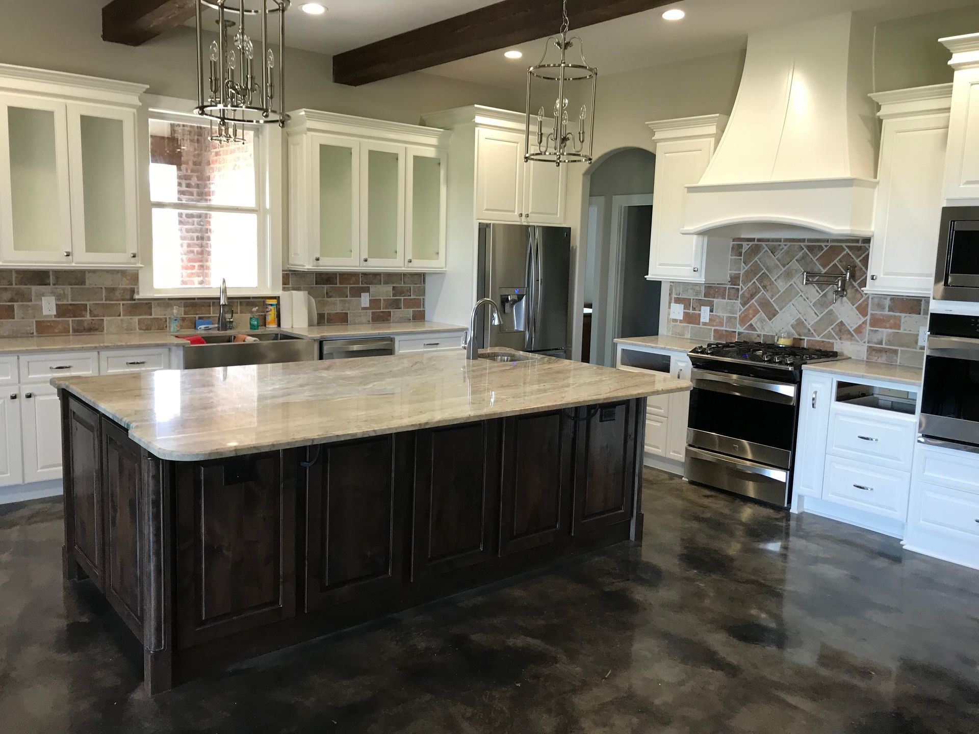 A kitchen with a large island and stainless steel appliances