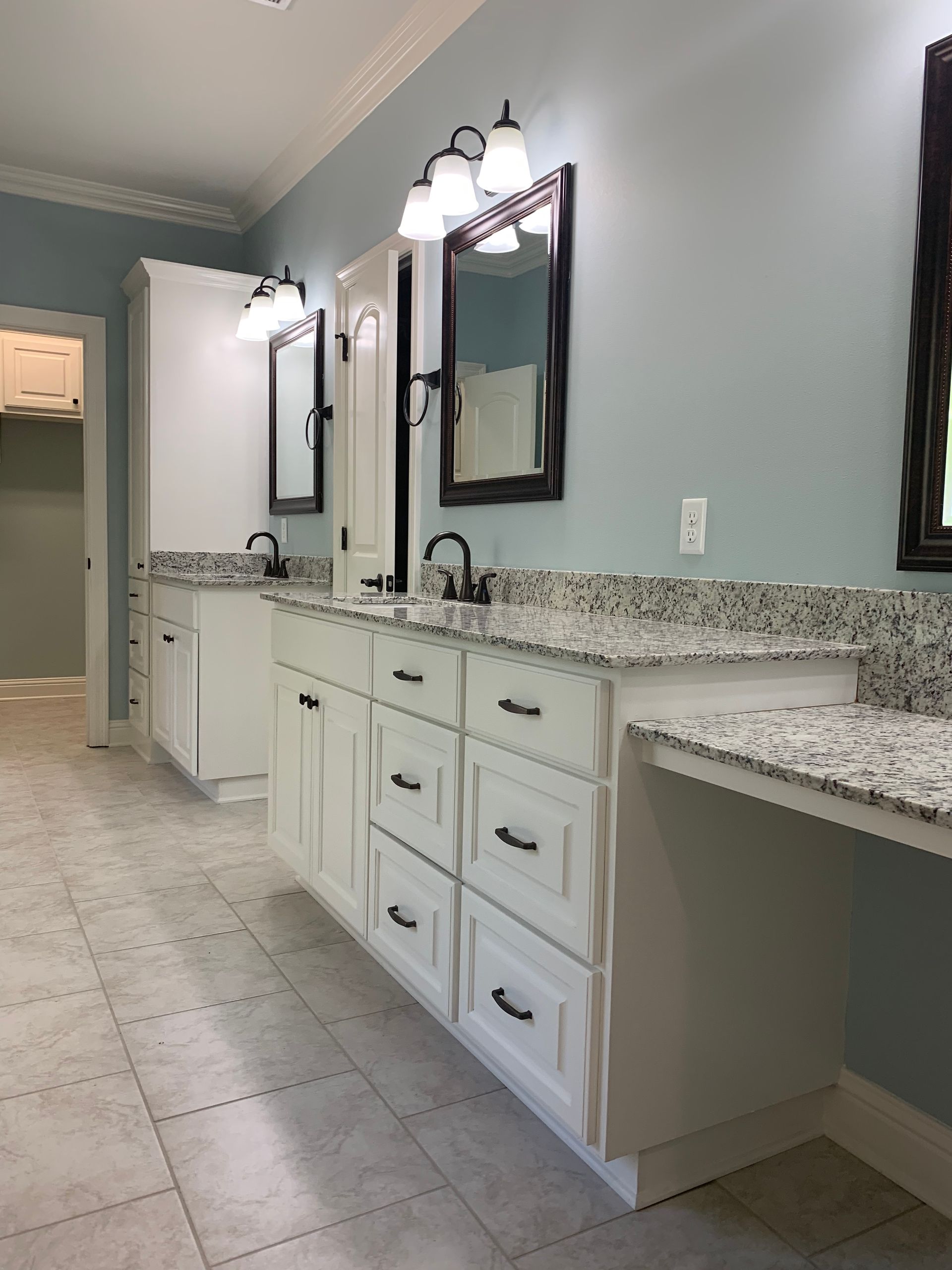 A bathroom with two sinks and two mirrors