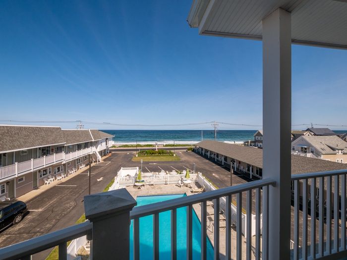 A view of the ocean from a balcony of a hotel.