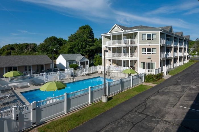 A large building with a swimming pool in front of it