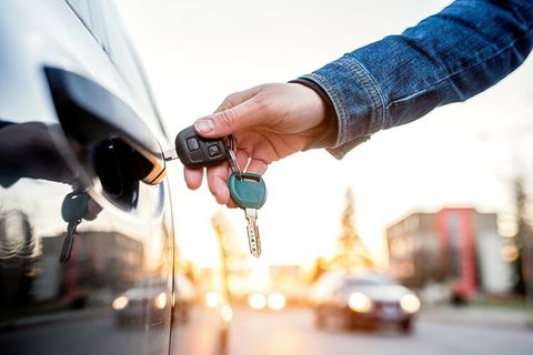 Woman Holding Car Key — Locksmith Services in Boswell, PA