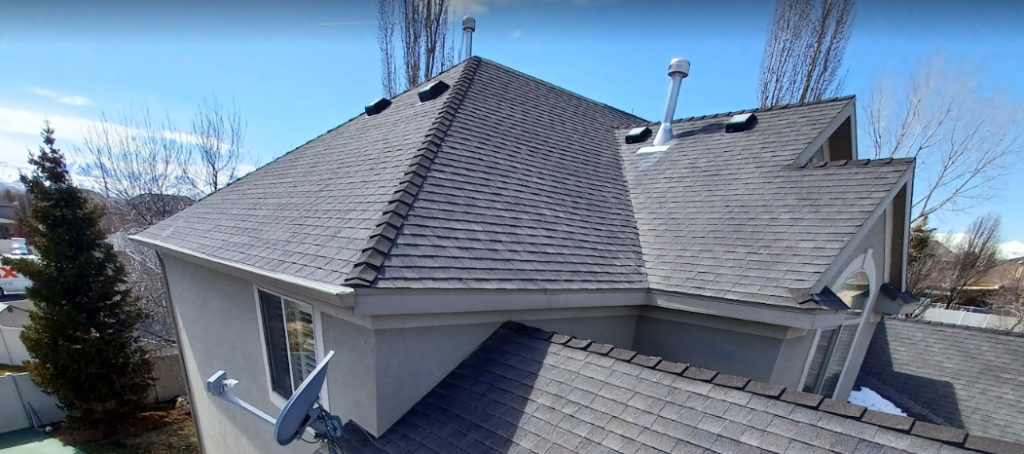 An aerial view of a house with a satellite dish on the roof.
