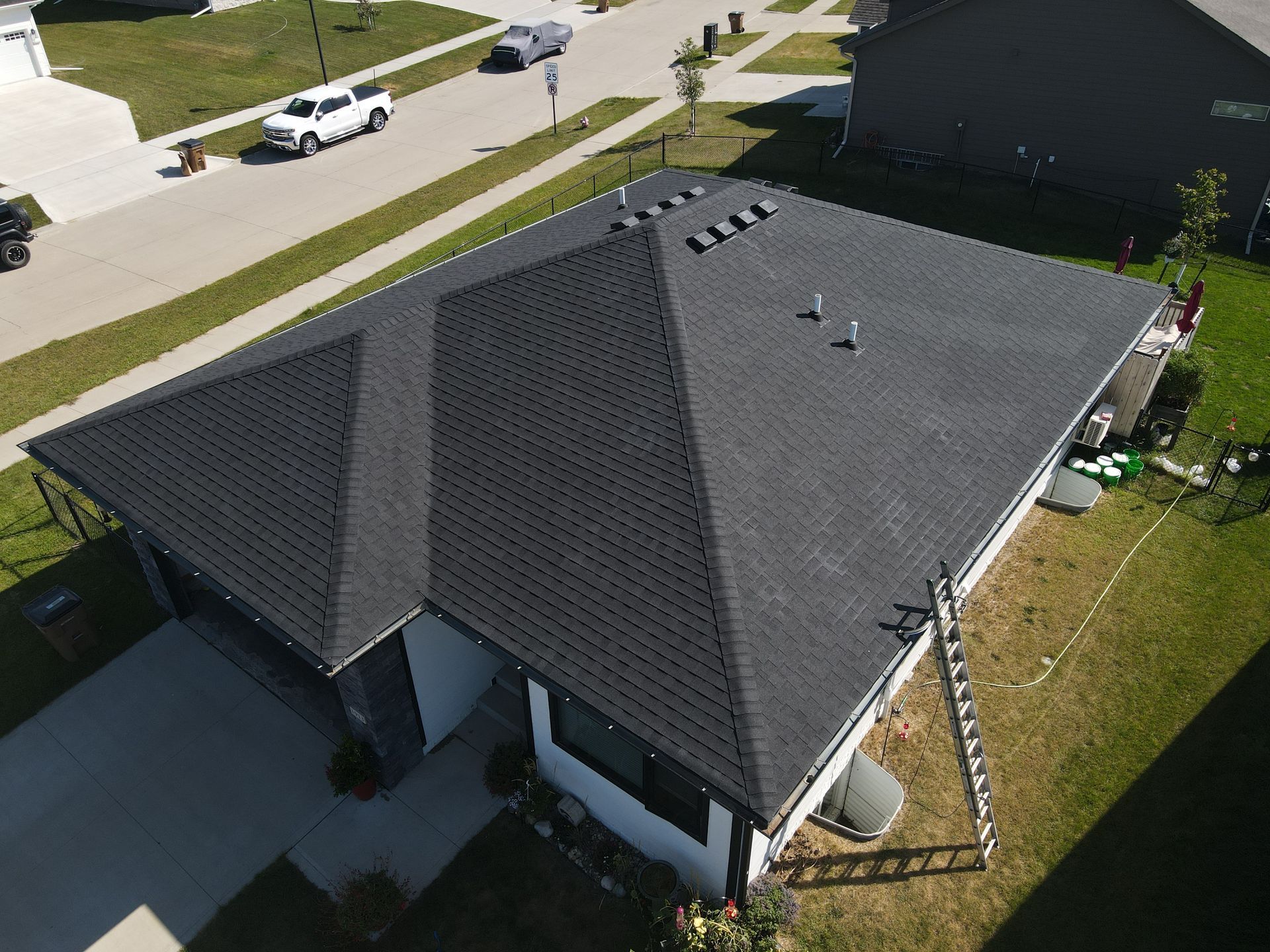 An aerial view of a house with a black roof.