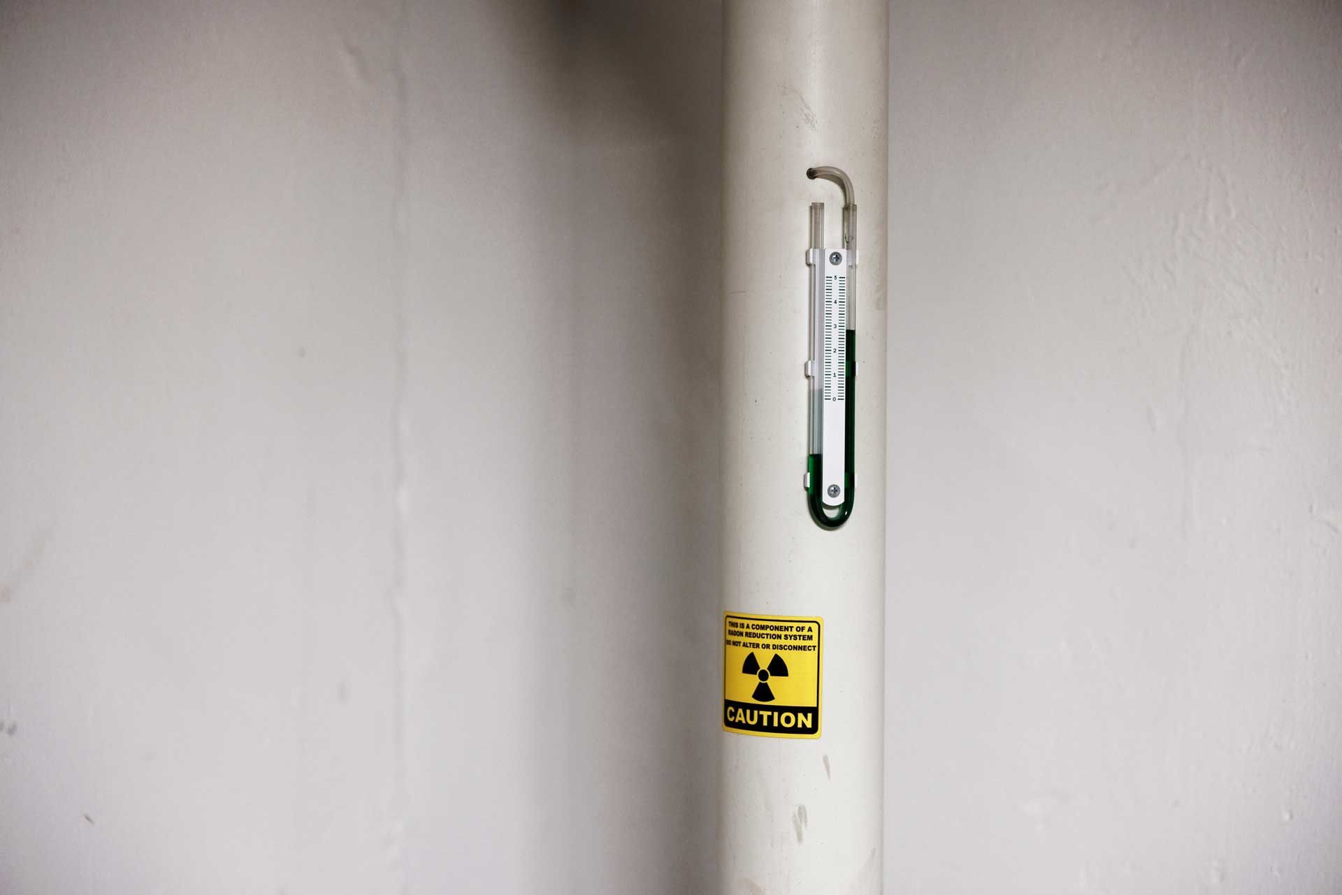 A white pipe with a caution sticker on it