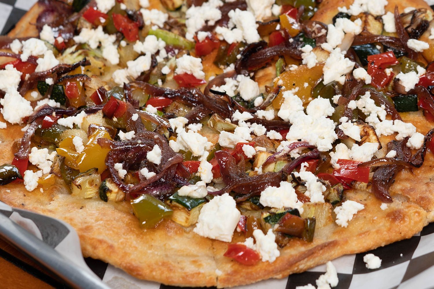 A pizza with a lot of vegetables and cheese on it