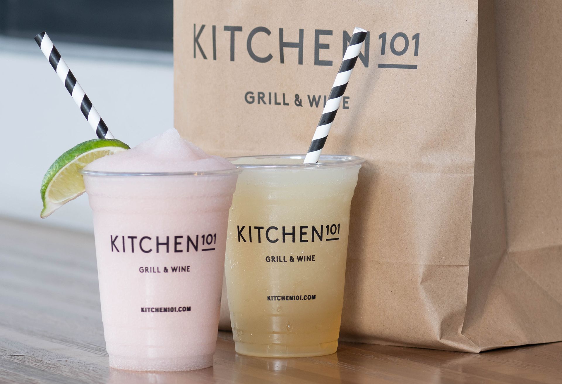 Two kitchen 101 drinks next to a kitchen 101 bag