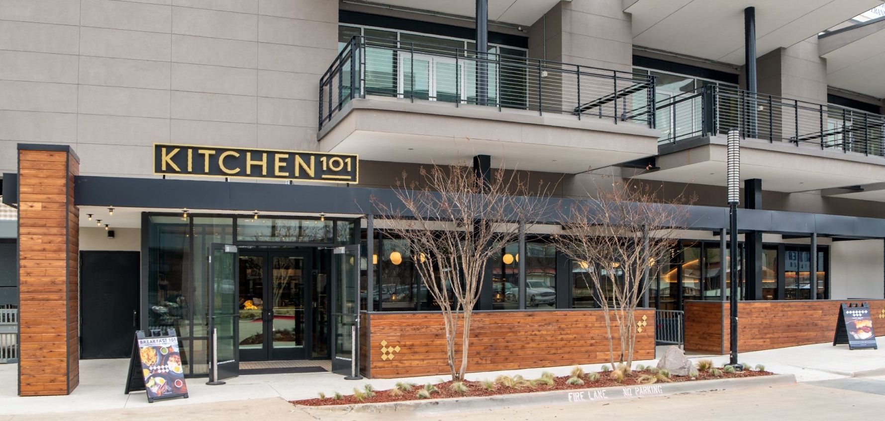 A large building with a balcony and a sign that says kitchen on it.