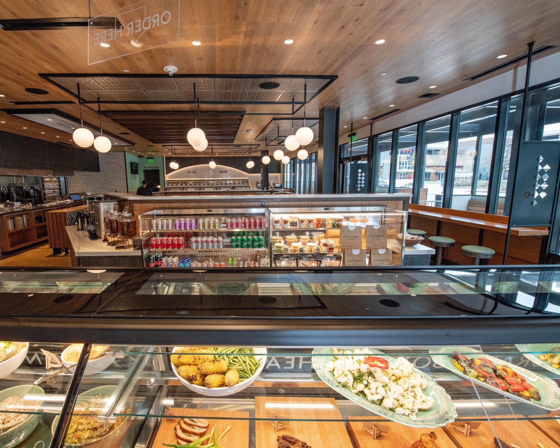 A restaurant with a display case filled with food and drinks.