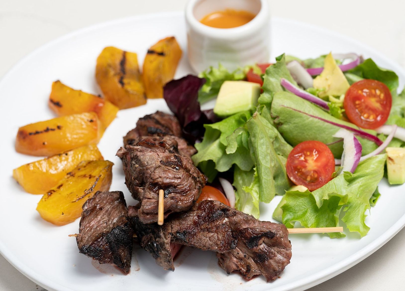 A plate of food with meat and vegetables on a table
