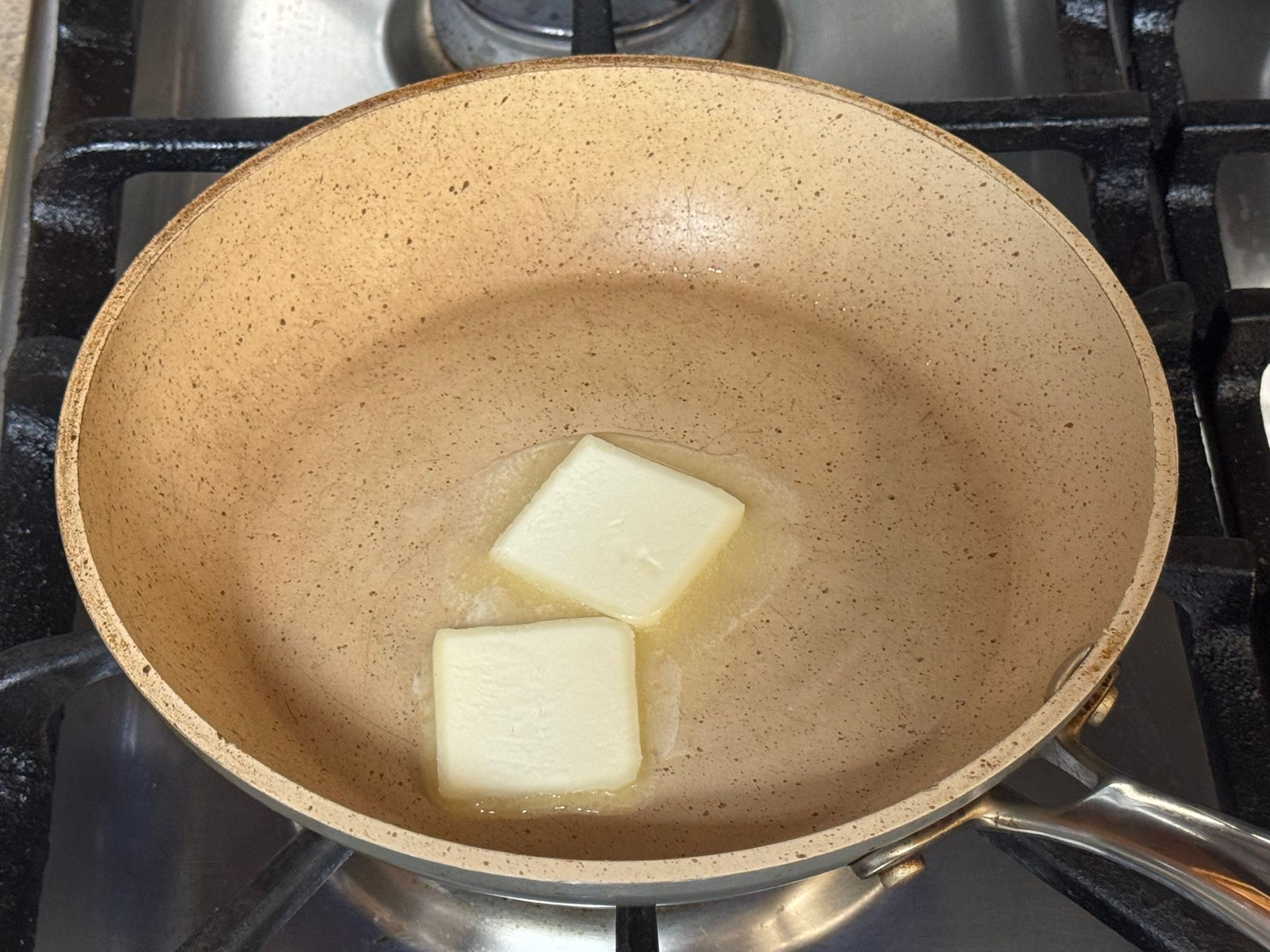 A close up of a tortilla with meat and rice on a cutting board.