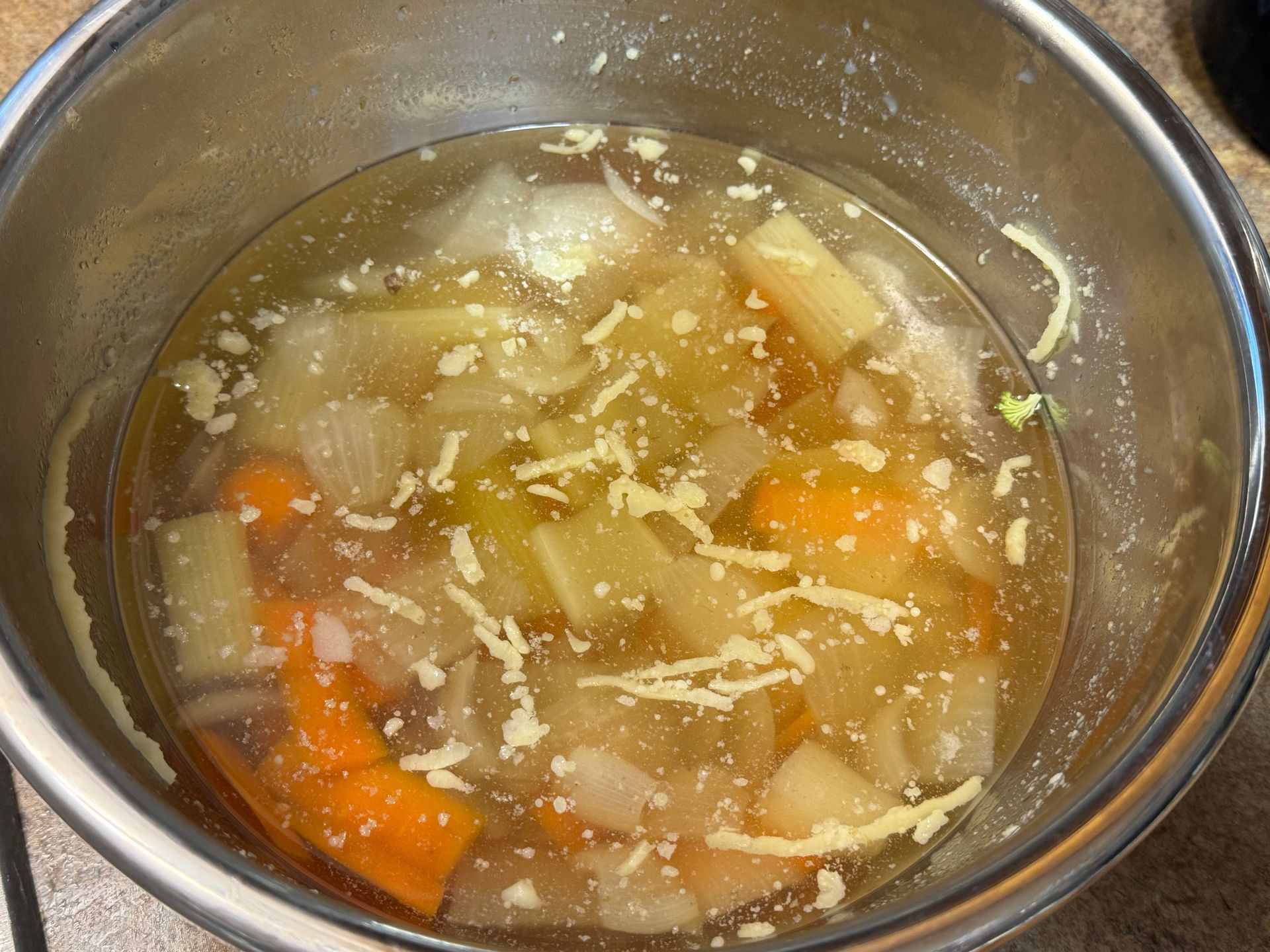 Chopped celery onions and potatoes on a cutting board
