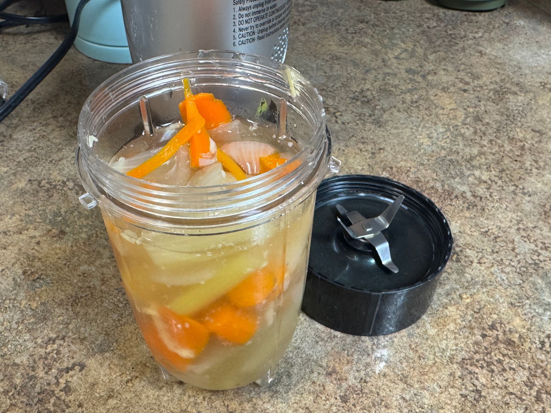 A close up of a bowl of soup with shrimp and potatoes.