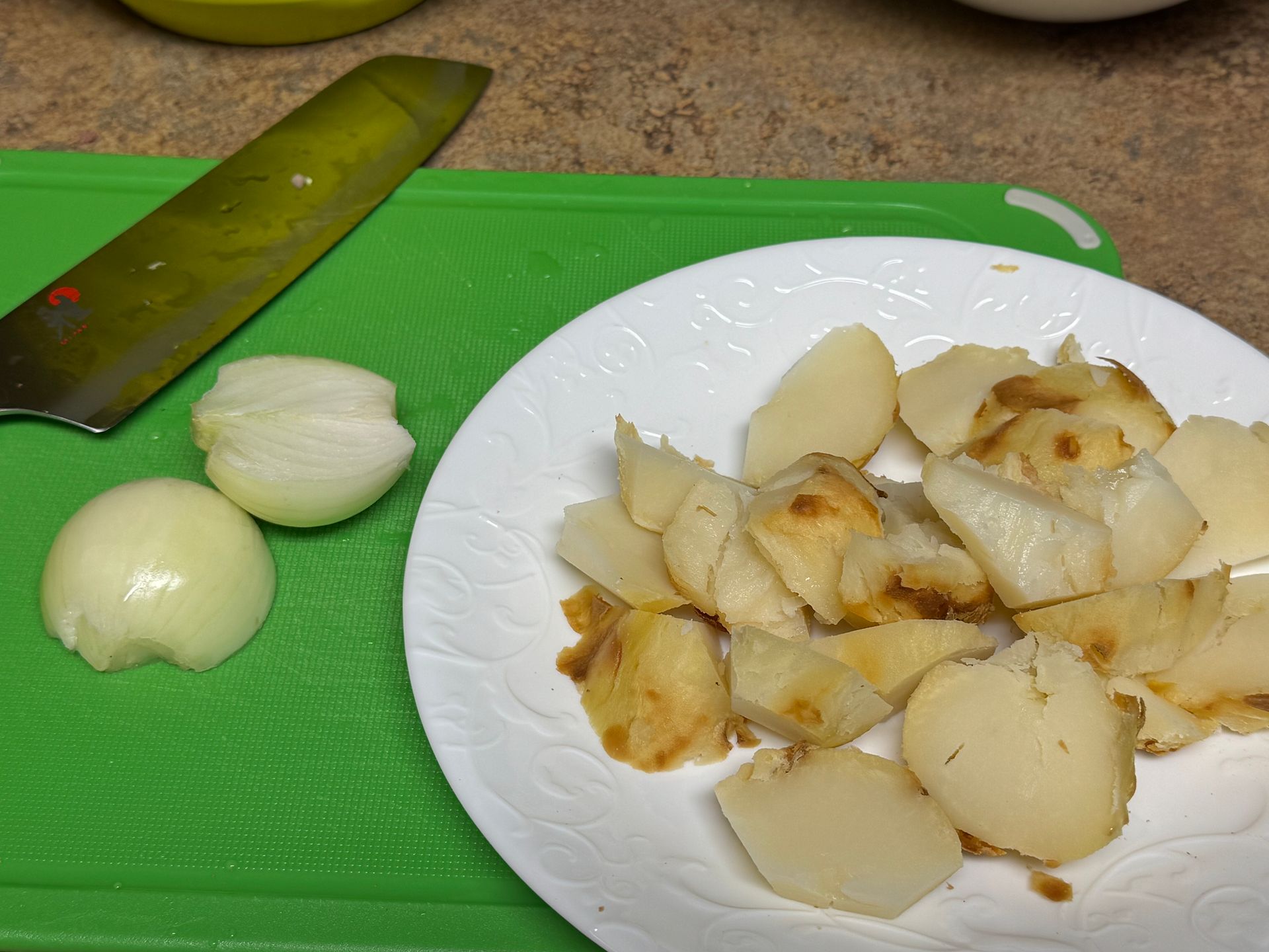 A pot filled with rice and greens is being cooked