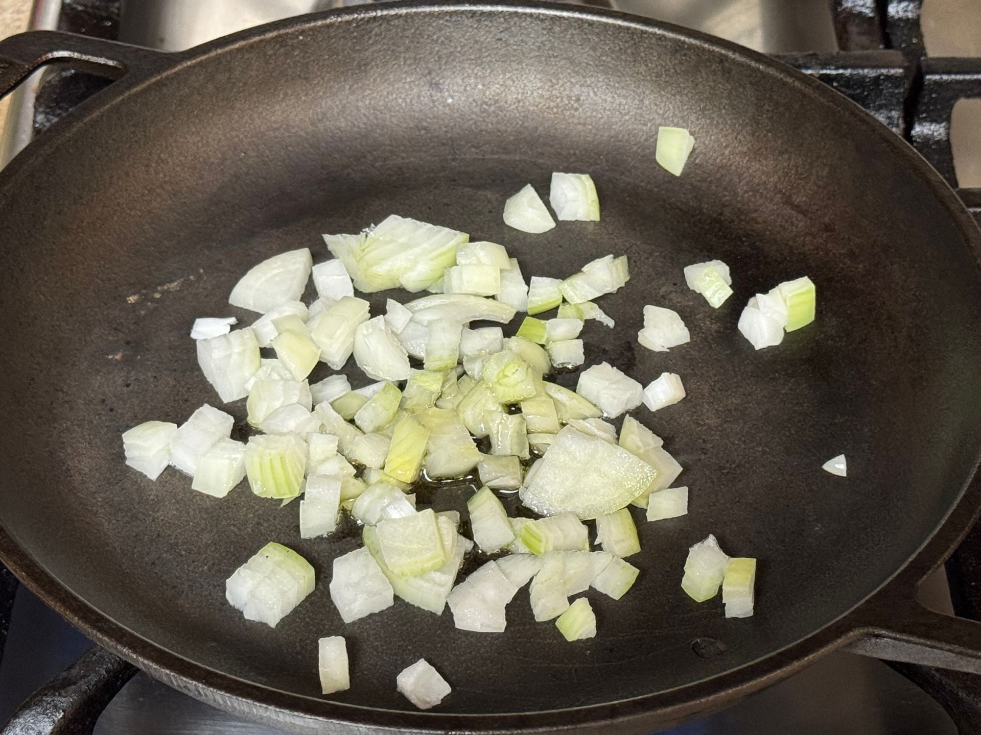 A close up of a tortilla with meat and rice on a cutting board.