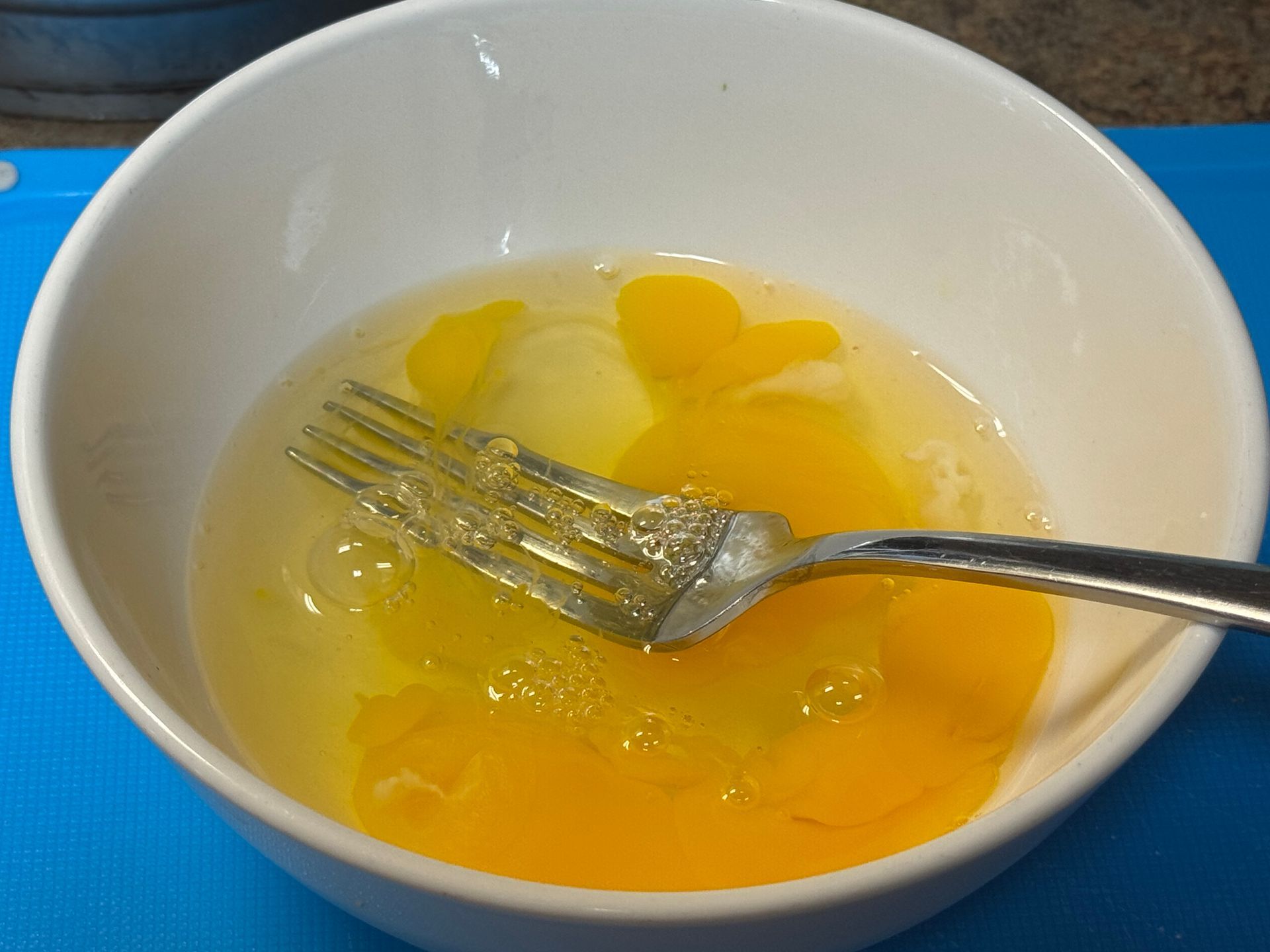 A pot filled with rice and greens is being cooked