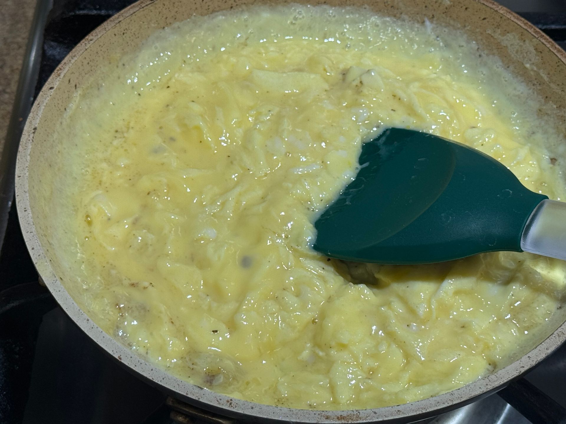 A person is rolling a burrito on a cutting board.