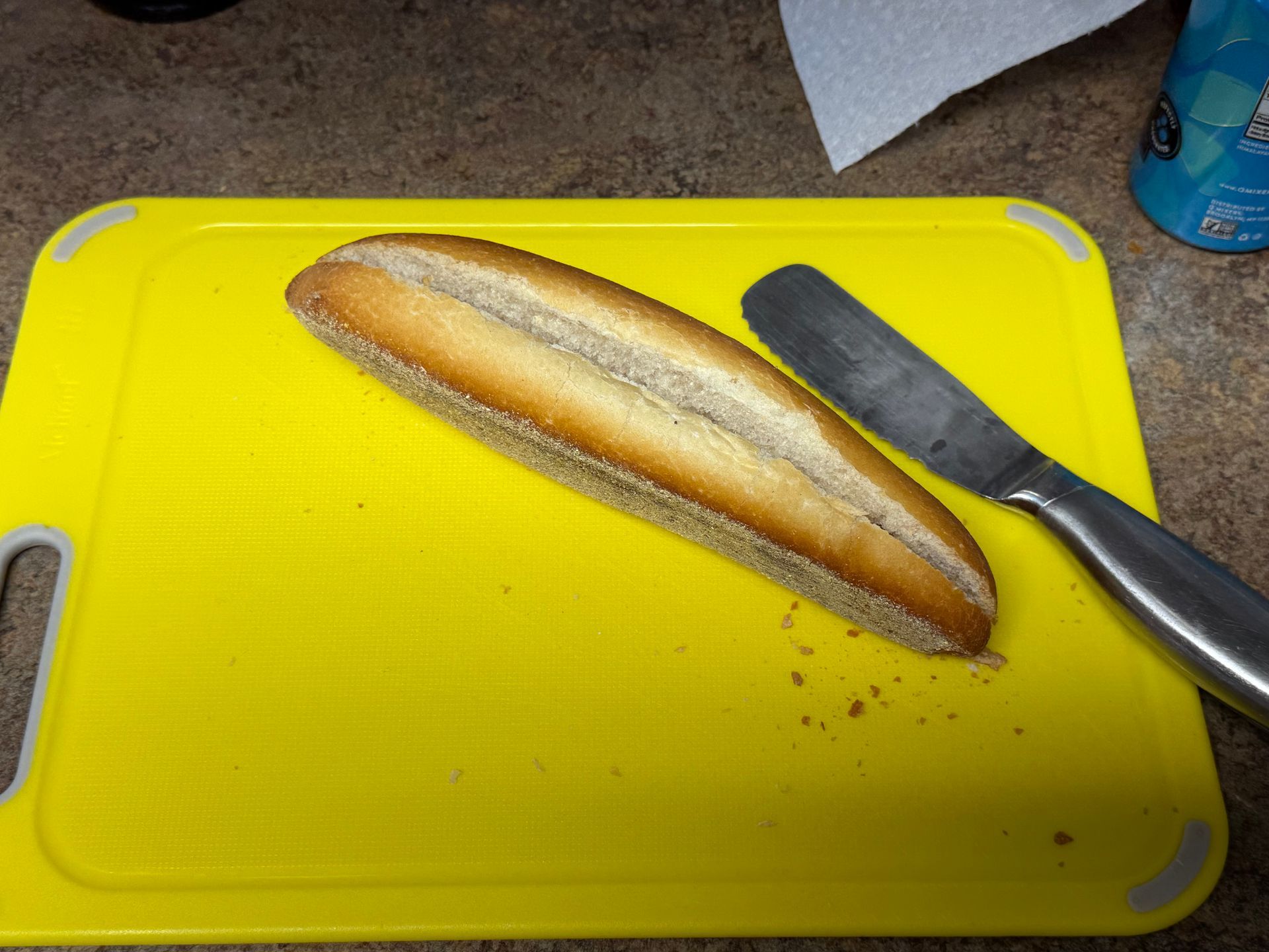 A row of sausages wrapped in plastic next to a pair of scissors