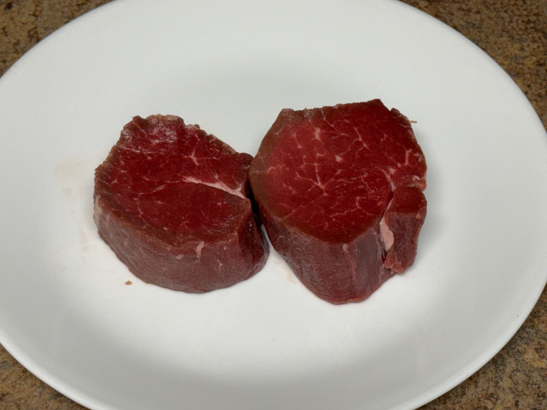 A large piece of meat is cooking on a grill