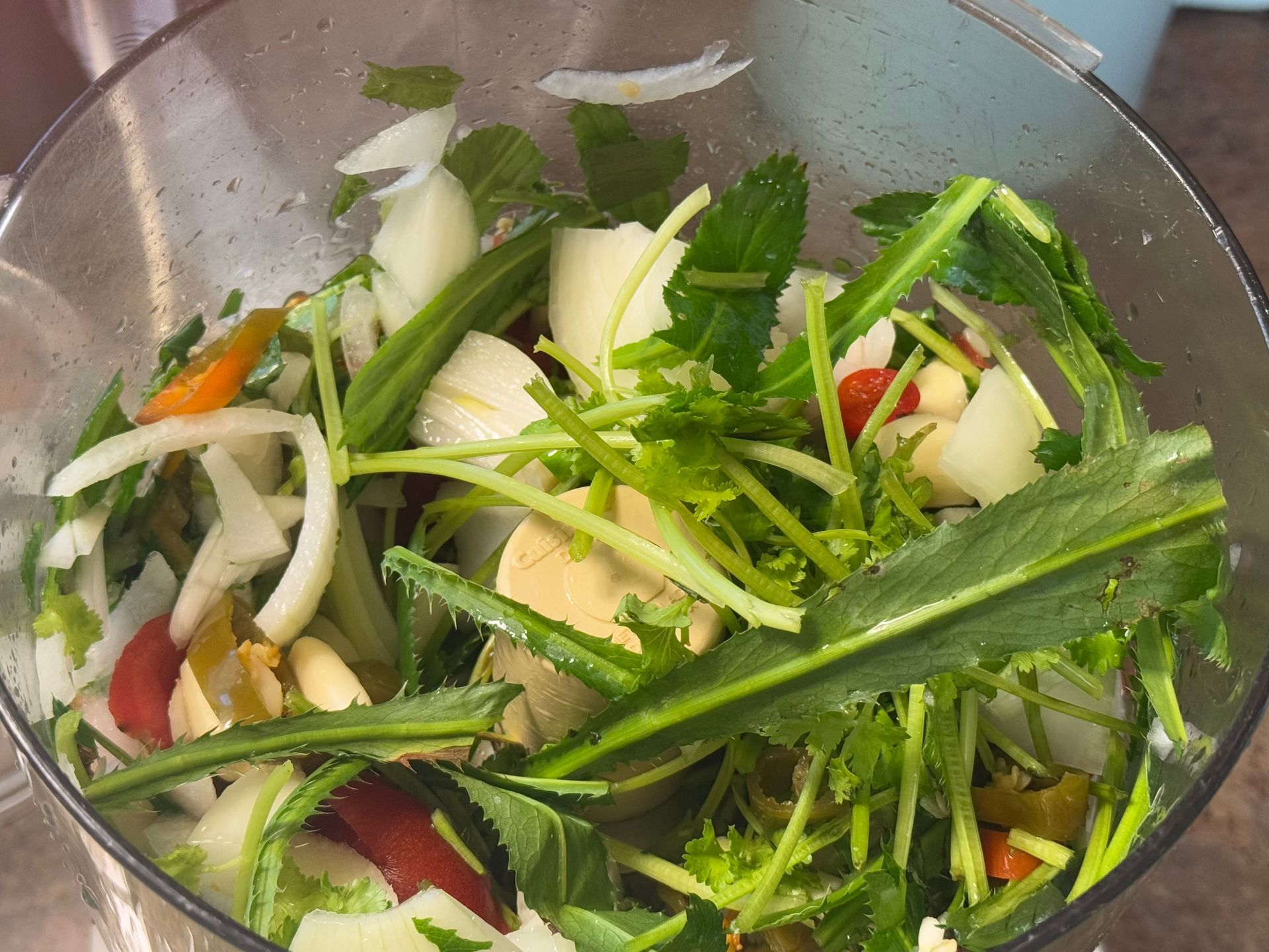 A pot filled with rice and greens is being cooked