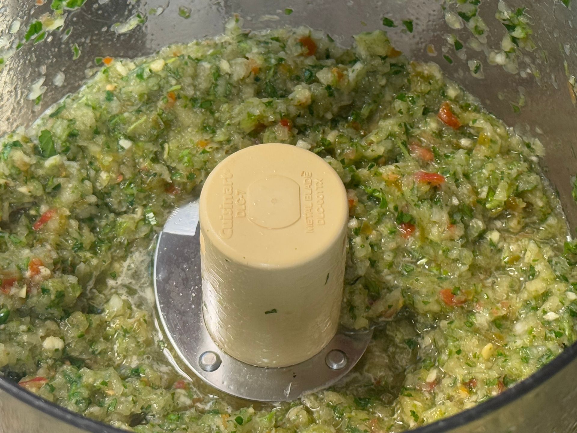 A close up of a tortilla with meat and rice on a cutting board.