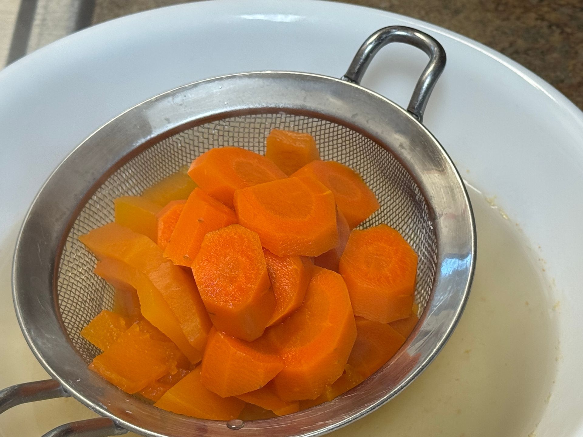 A close up of a bowl of soup with shrimp and potatoes.