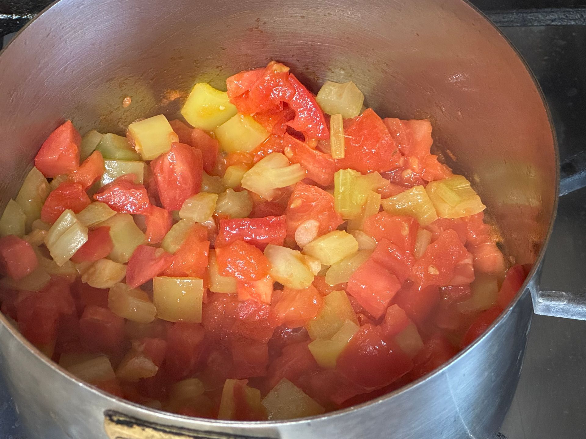 Chopped celery onions and potatoes on a cutting board