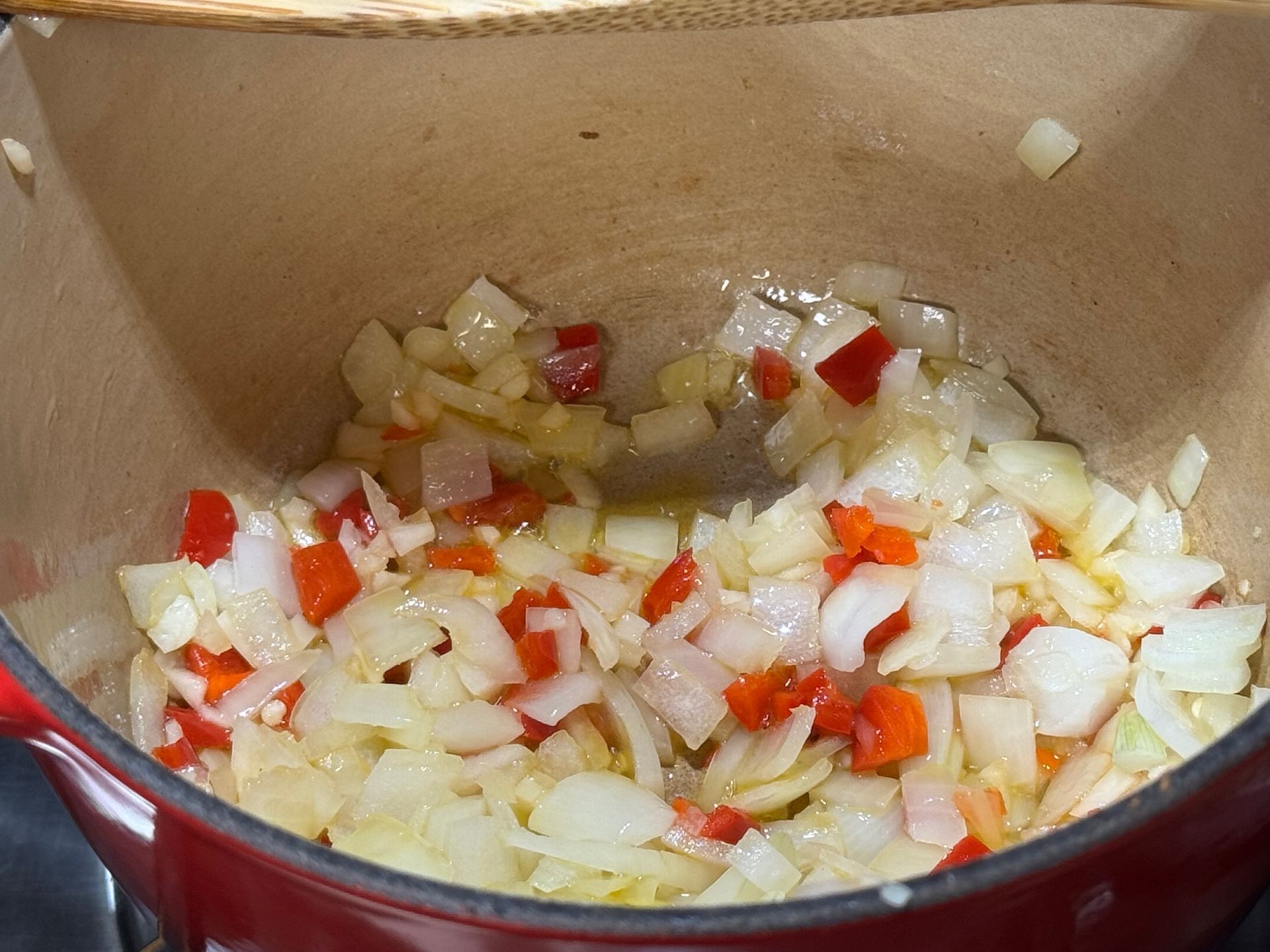 A close up of a bowl of soup with shrimp and potatoes.