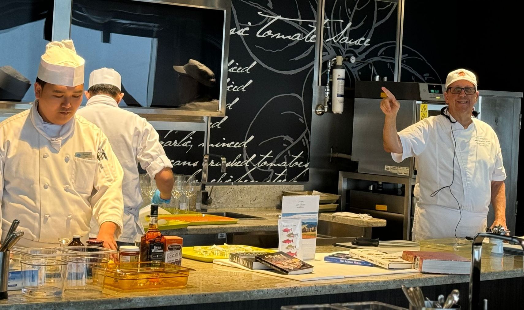 A group of chefs are preparing food in a kitchen