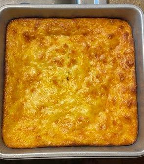 A pan of cornbread is sitting on a table.