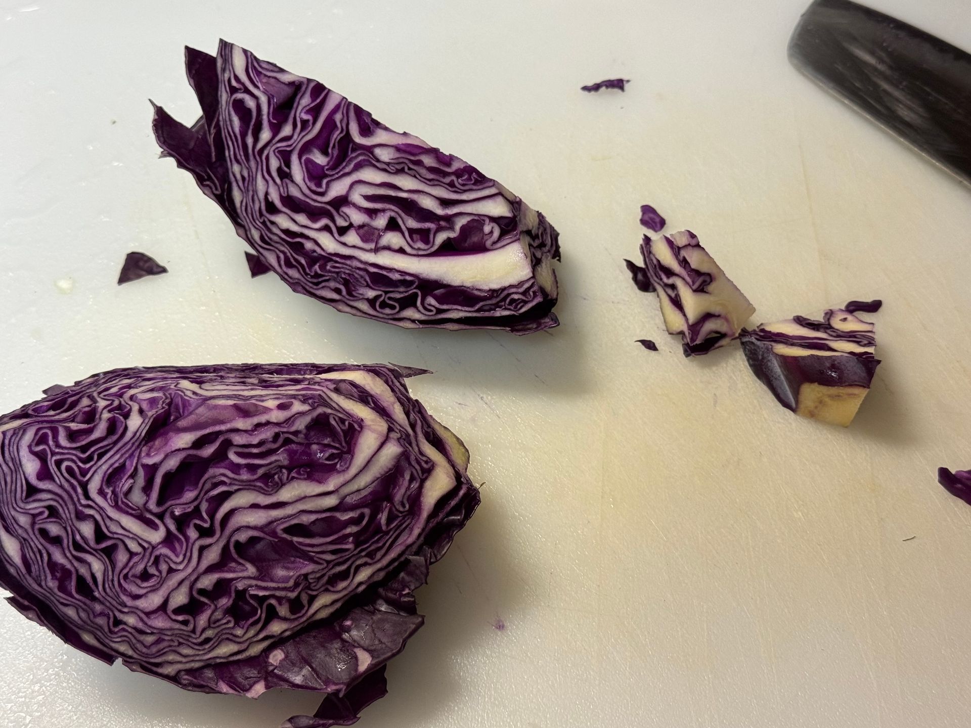 Brussels sprouts are being cooked in a pot of water on a stove.