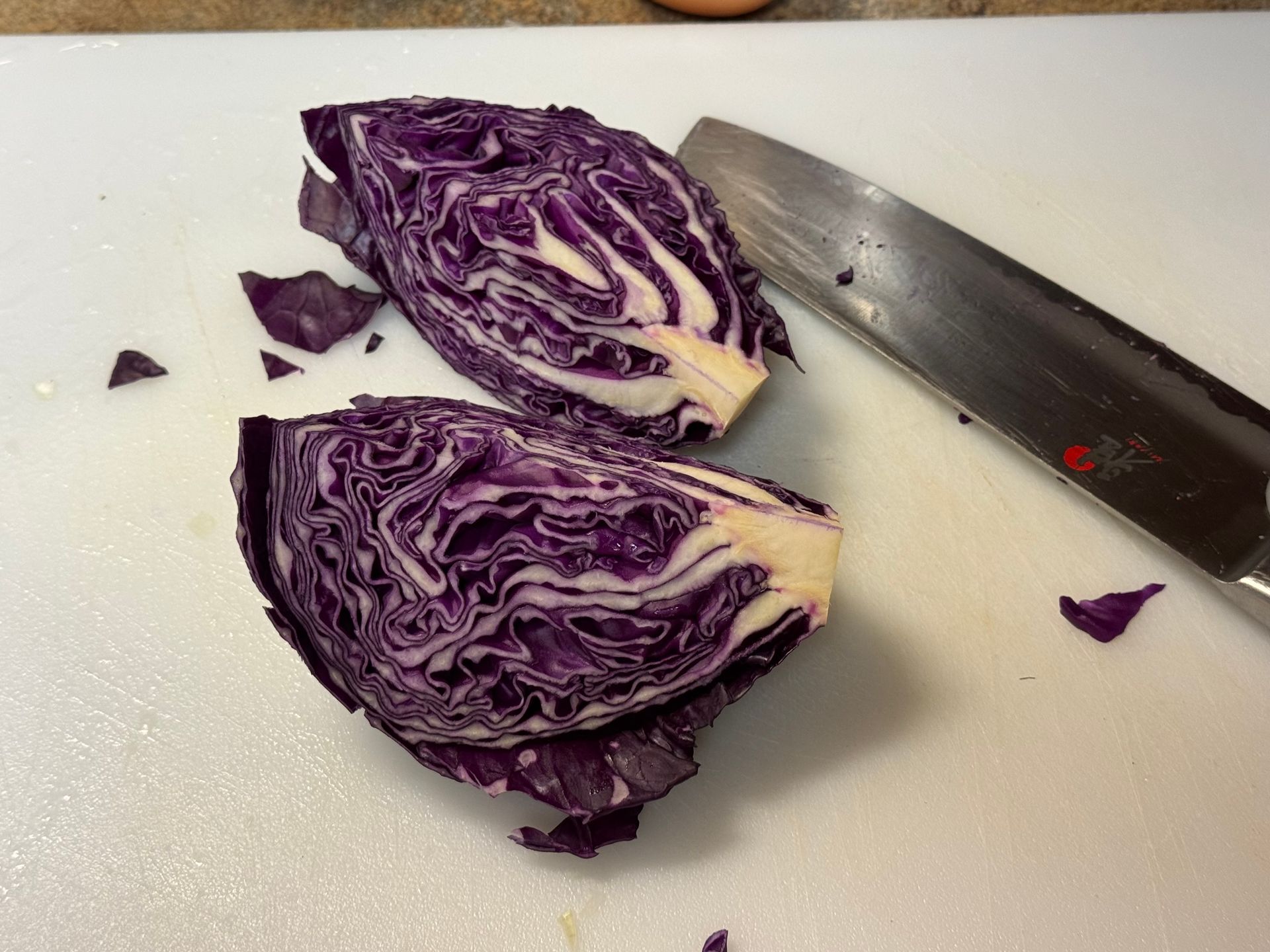 Three bowls of brussels sprouts are sitting on a table.