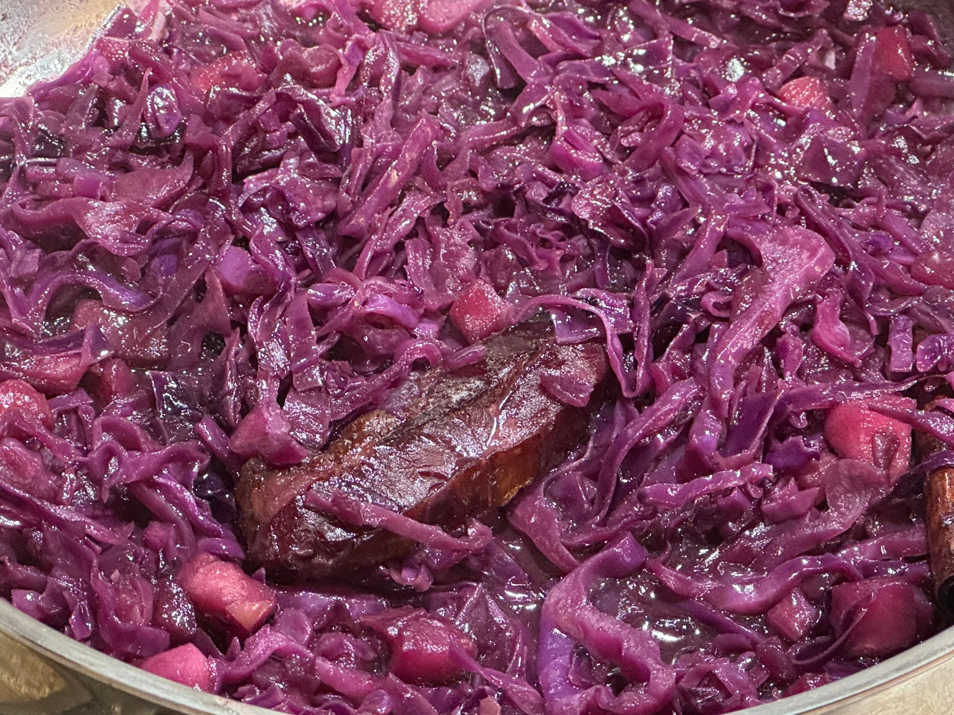 A bowl of green vegetables with carrots and celery