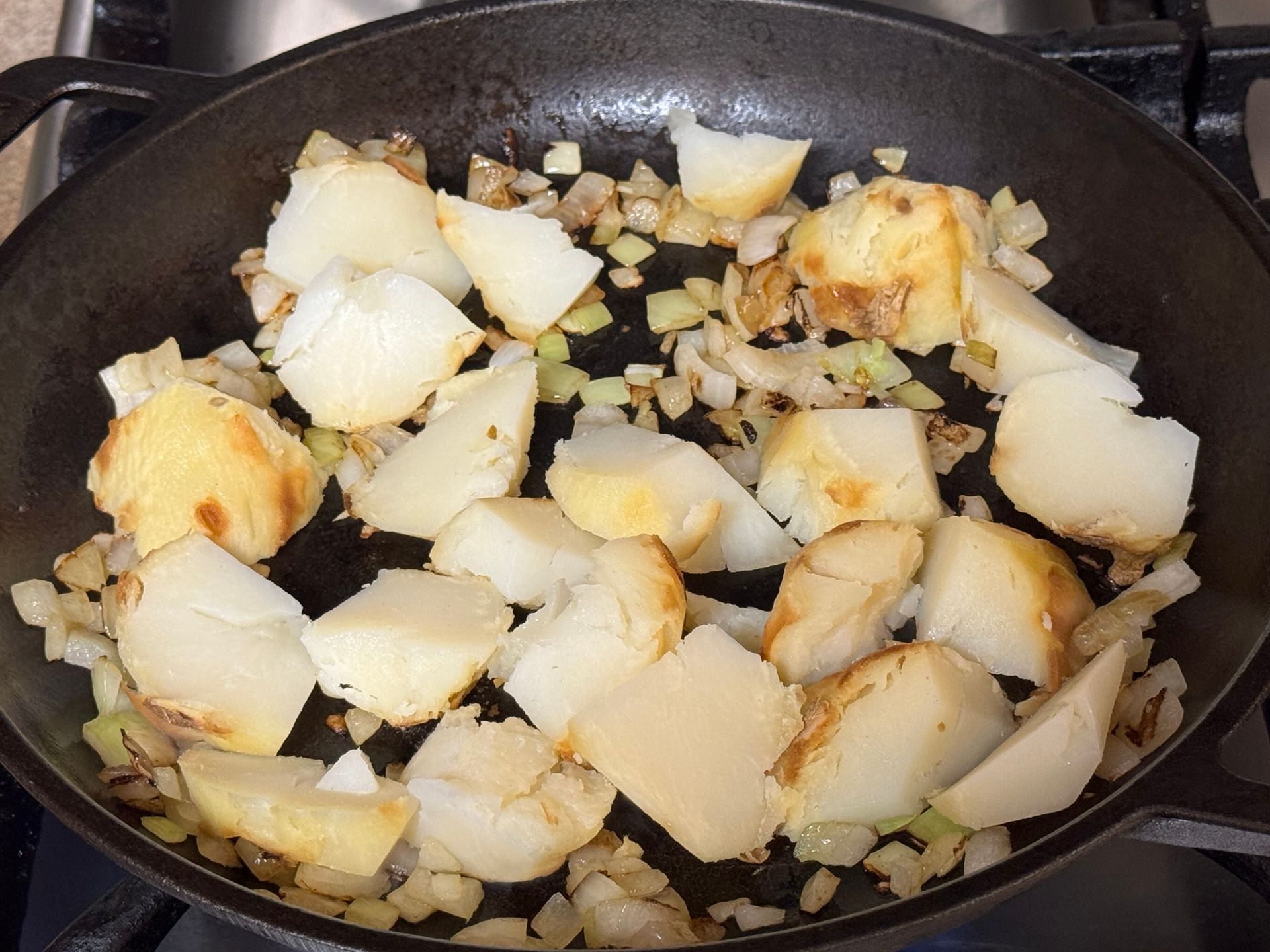 A person is rolling a burrito on a cutting board.