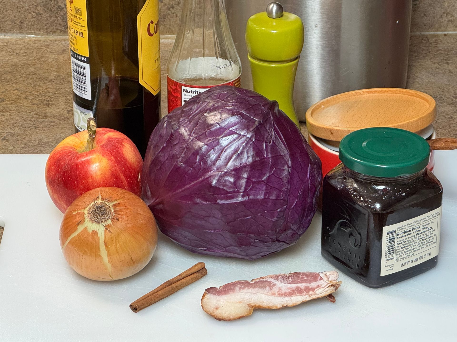 A white plate topped with sliced brussels sprouts on a counter.