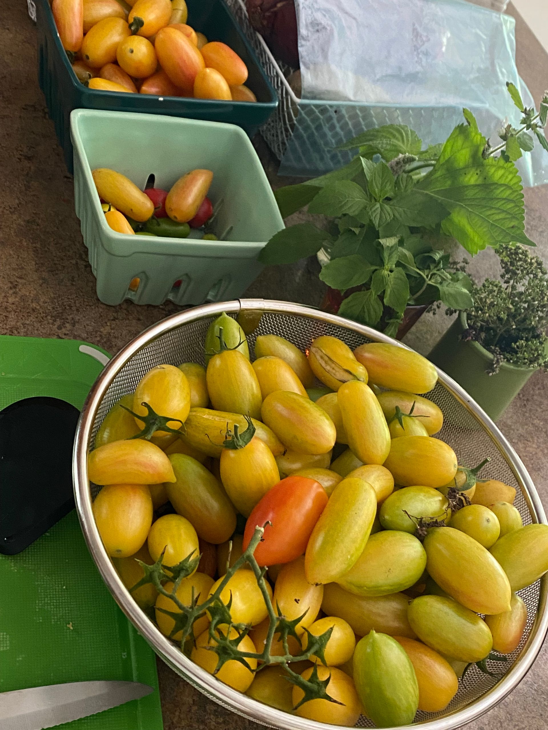 A bowl of yellow tomatoes sits on a table