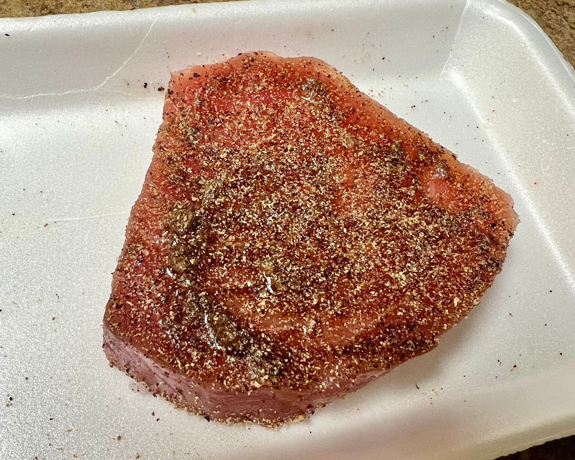 A piece of meat is on a styrofoam tray