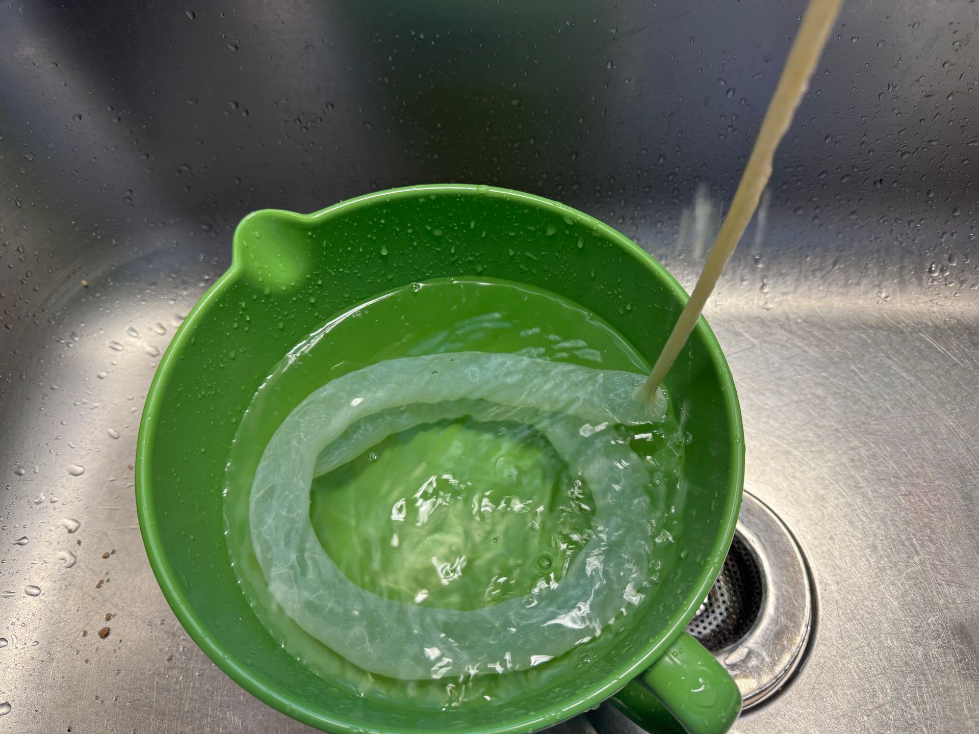 A pair of scissors is sitting next to a plastic bag.