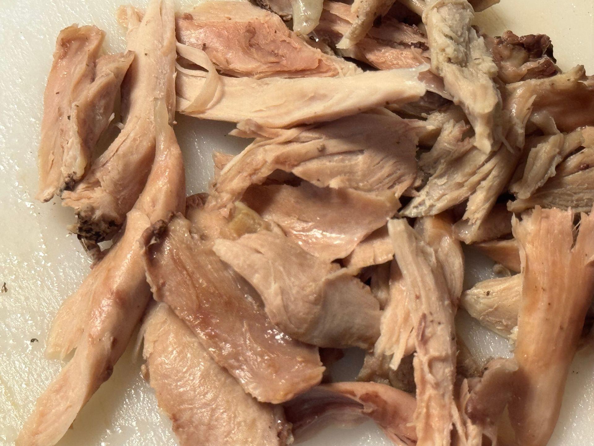 A close up of a bowl of soup with shrimp and potatoes.