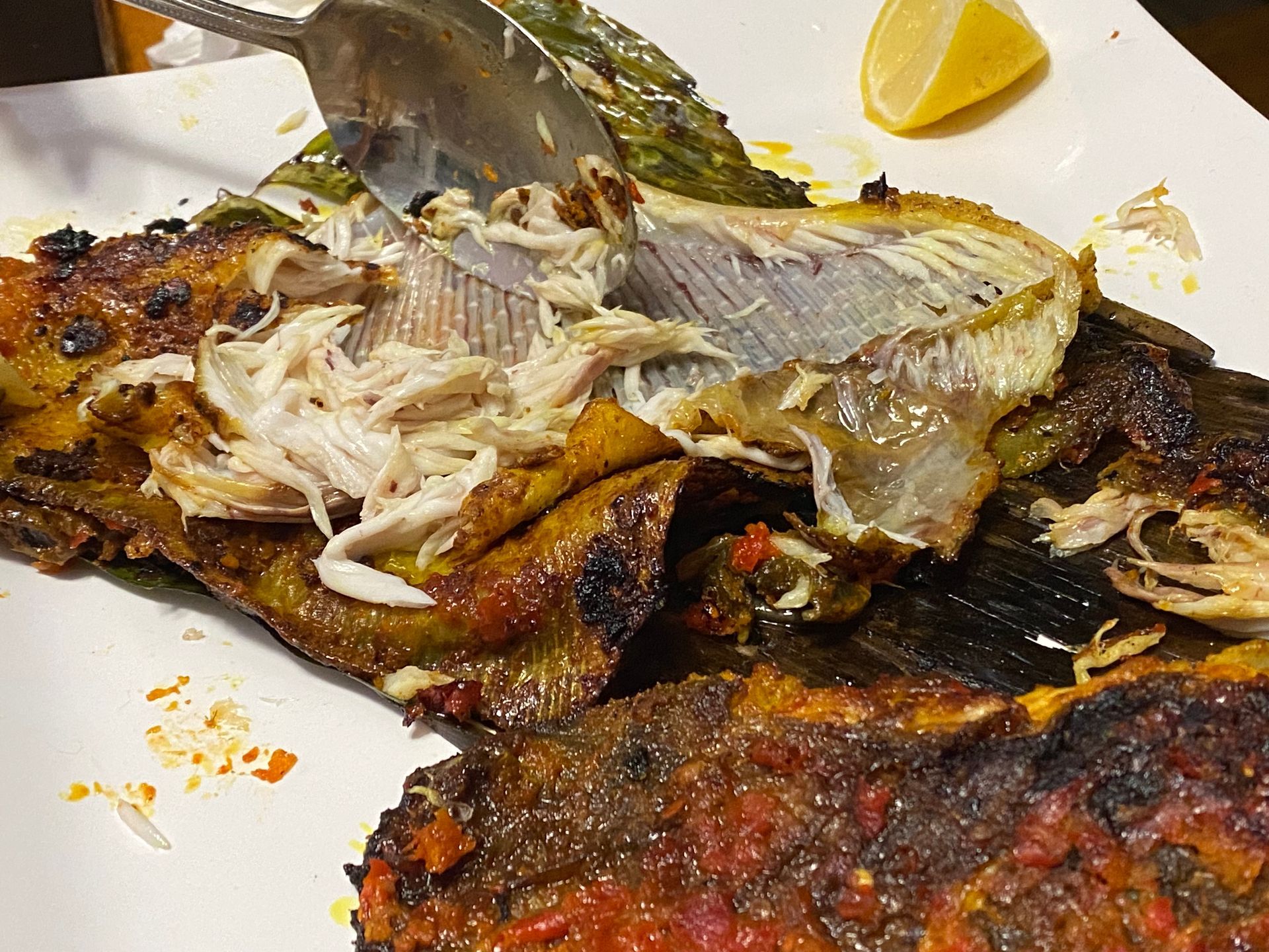 A close up of a plate of food with a spoon in it.