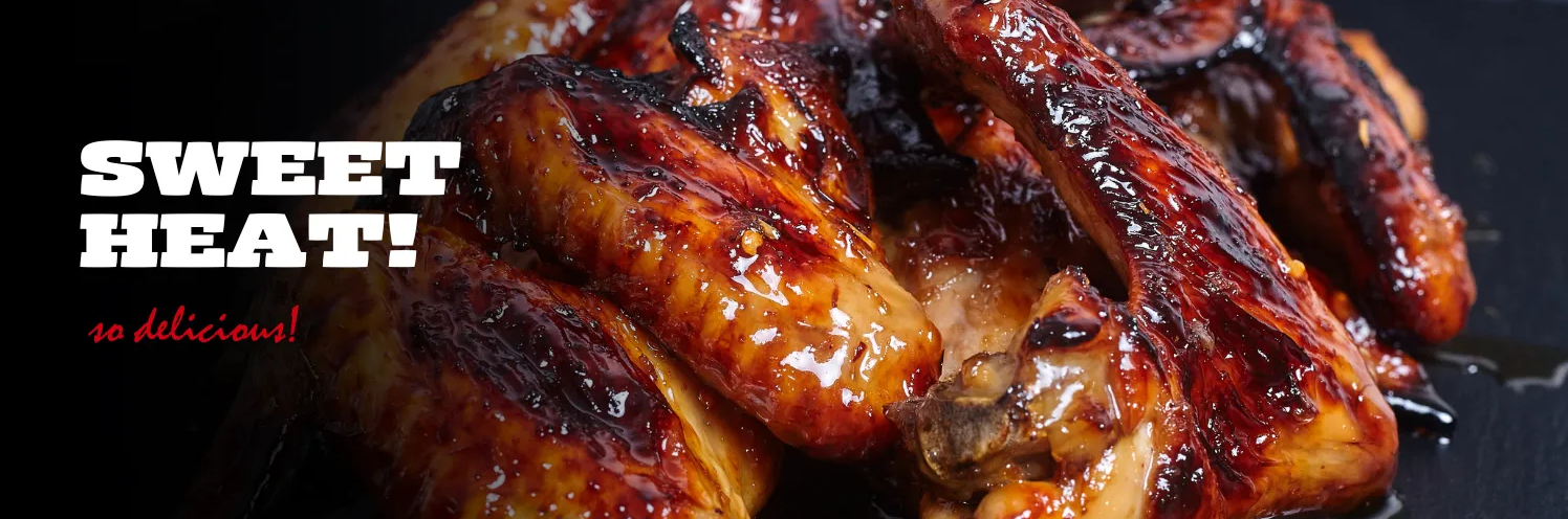 A close up of chicken wings with the words sweet heat on the bottom