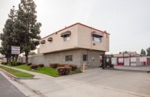 A large building with a gate in front of it and a lot of windows.