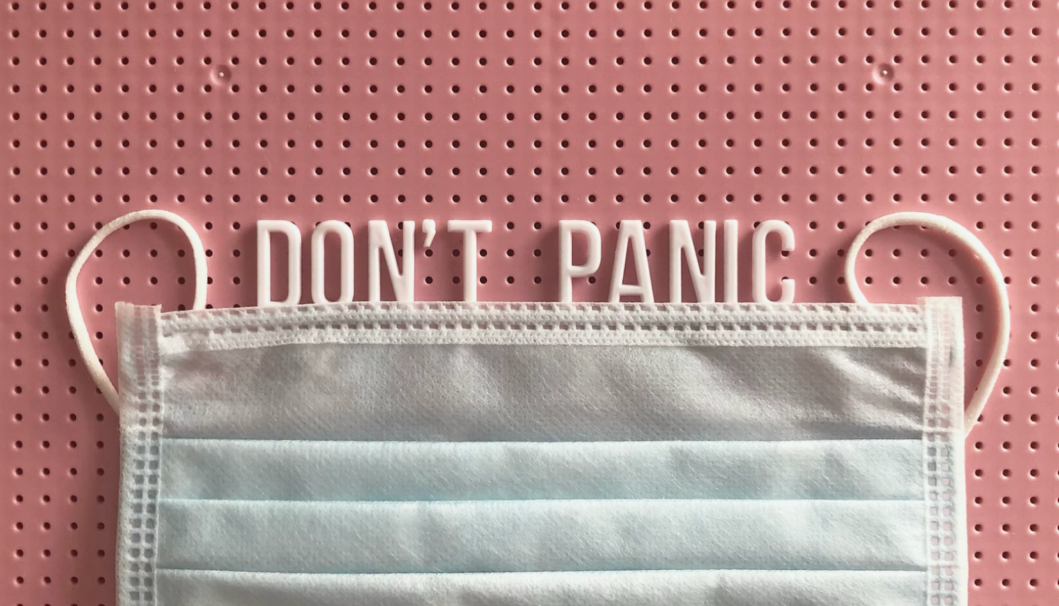 A face mask with the words `` do n't panic '' written on it.