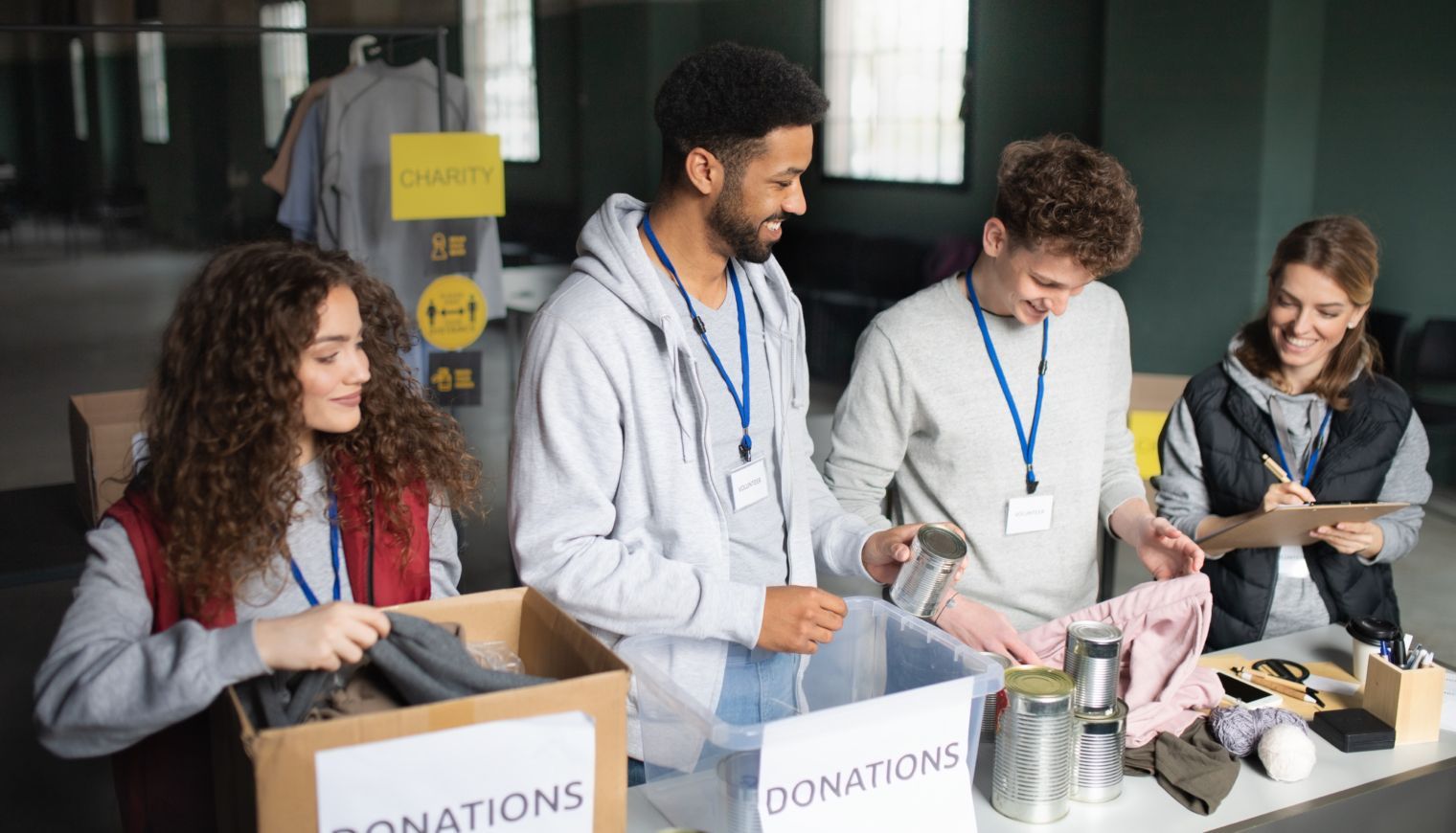 A group of people are standing around a table sorting donations.