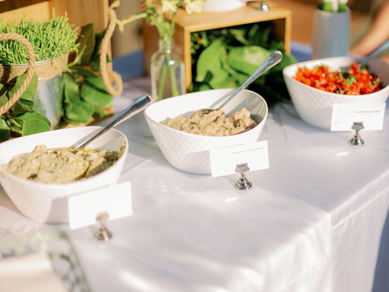 Salad with lemon slices on a tiered display at a buffet.
