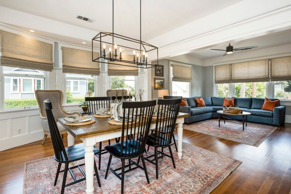 There is a dining table and chairs in the middle of the room.